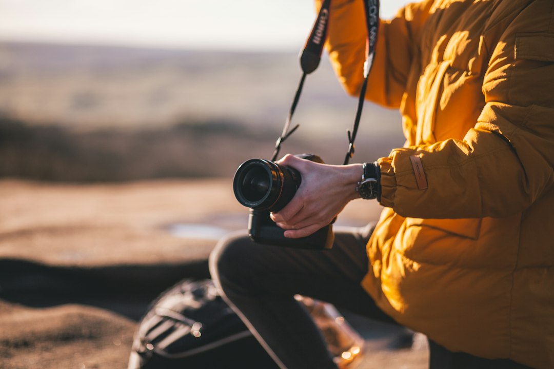 Photographer holding a camera in soft natural light, representing restored creative energy
